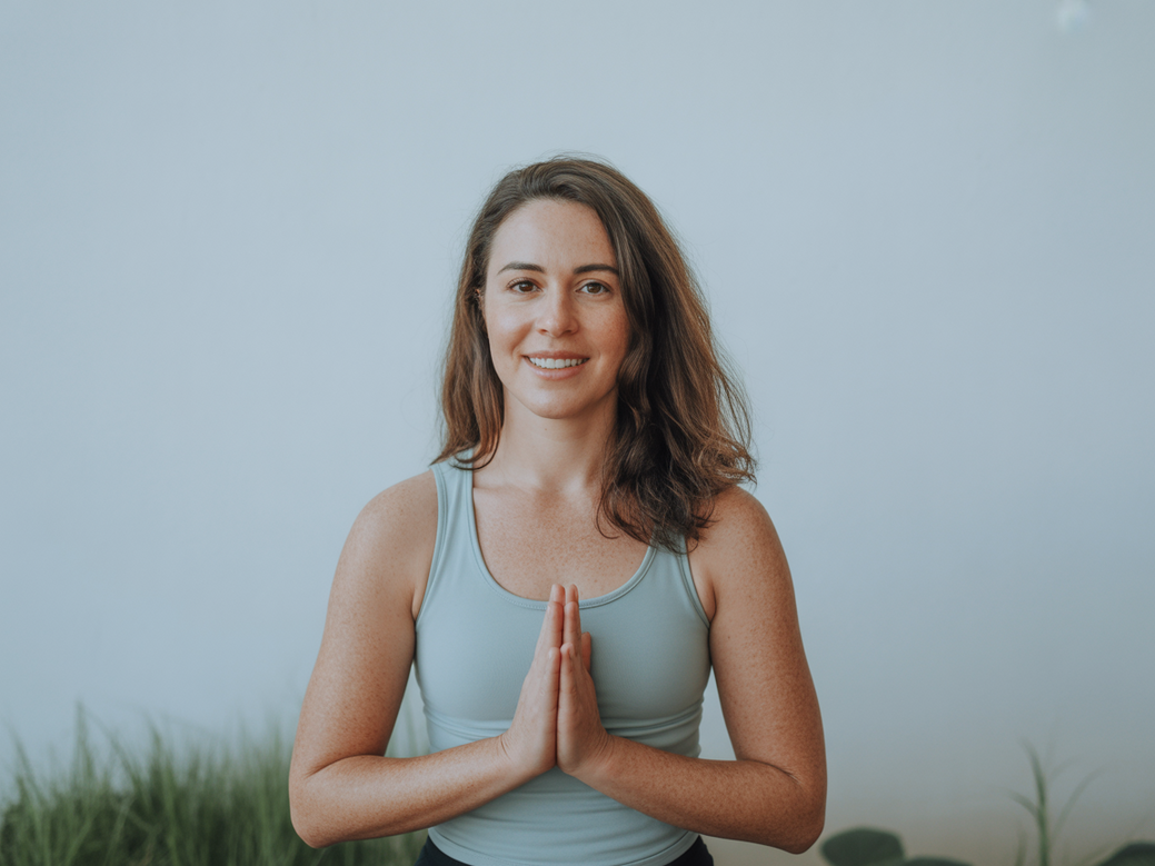 Luzia, co-founder of Vitalizen, demonstrating a yoga pose for office workers.
