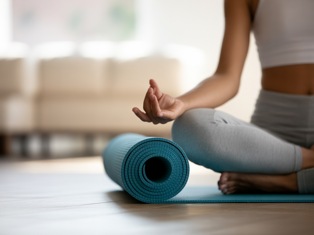 A person practicing yoga and meditation at home with the Vitalizen App